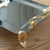 PLATEAU CARRE EN INOX ARGENTE AVEC ANSES DOREES